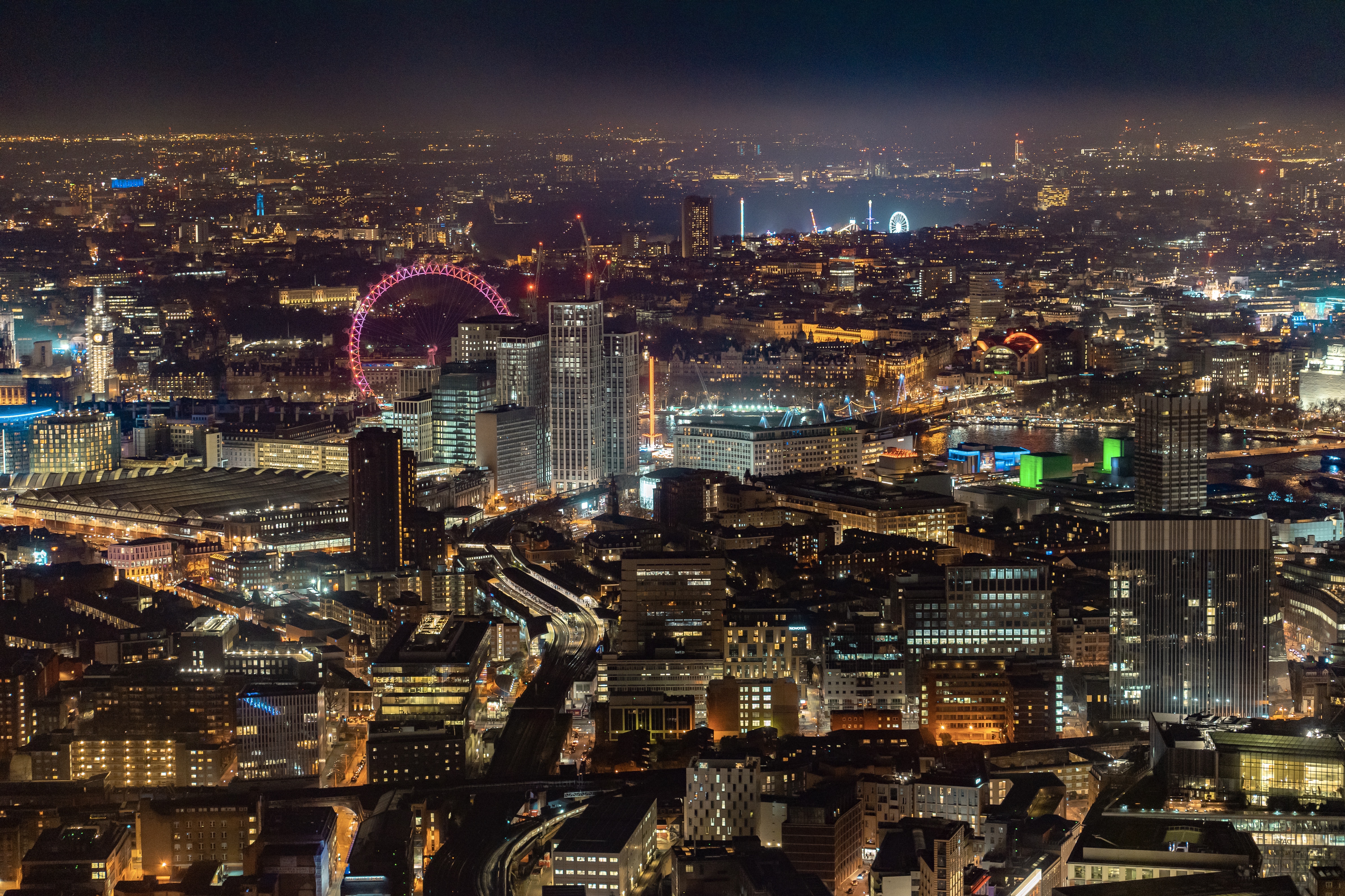 London illuminated at night beneath a hazy sky